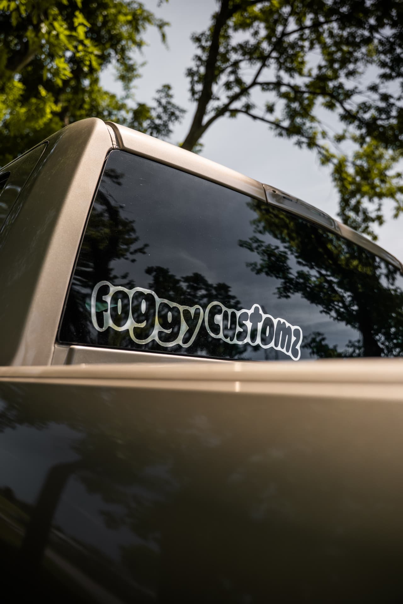 Foggy Customs decal on the rear window of a custom truck