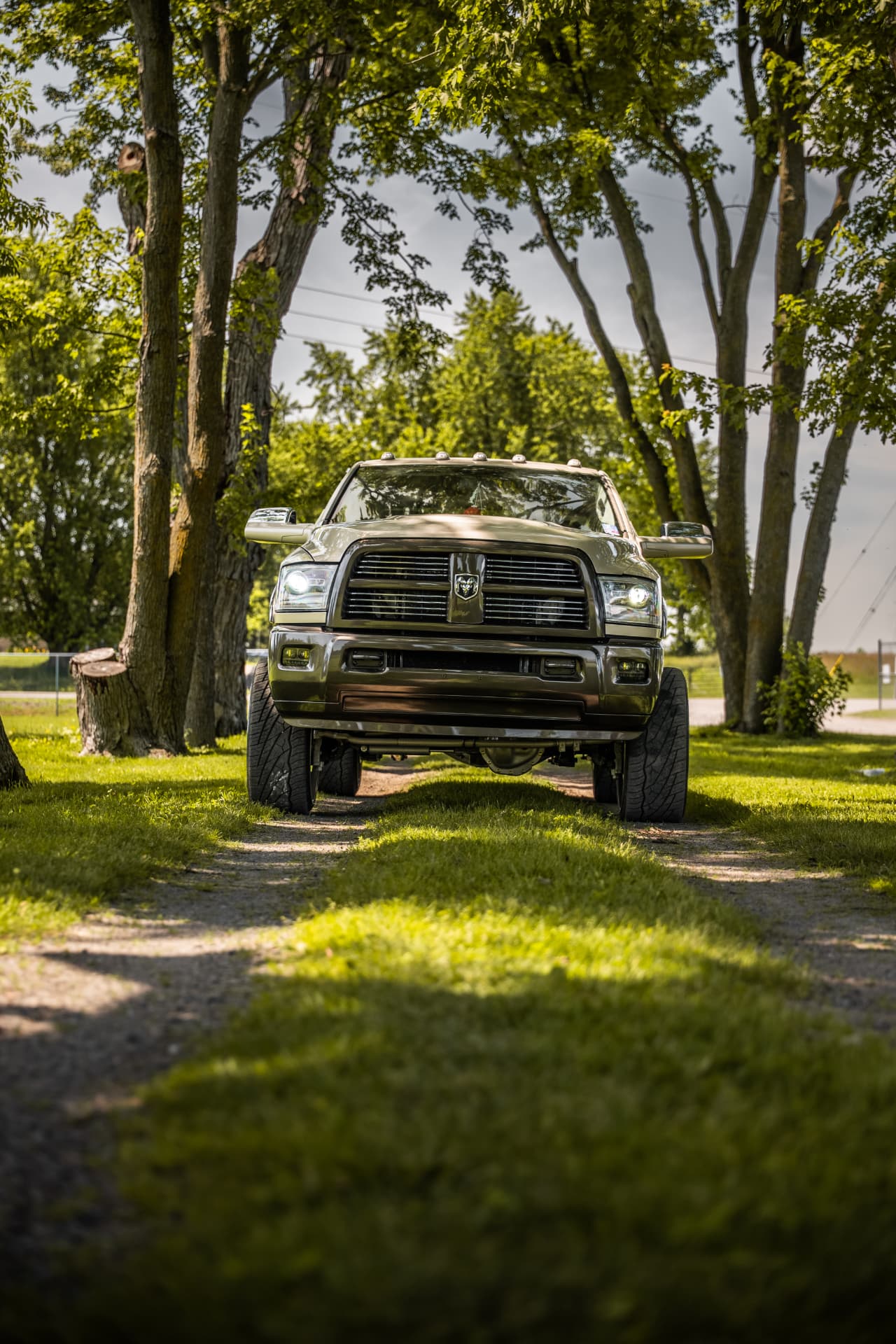 Head-on view of the custom Ram with lit headlights and cab lights
